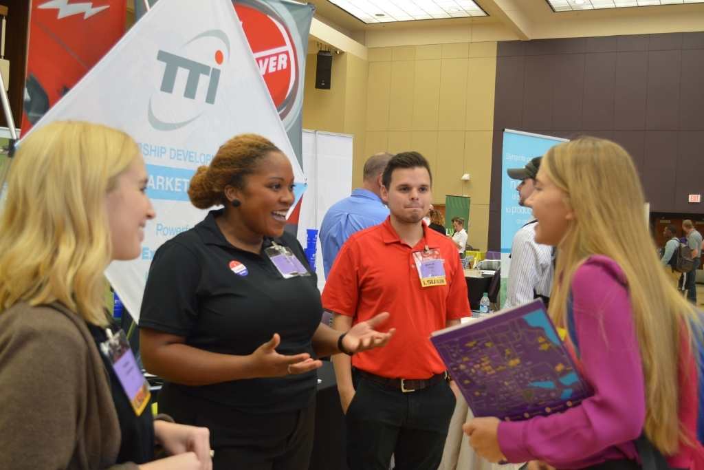 People talk at Career Fair booth