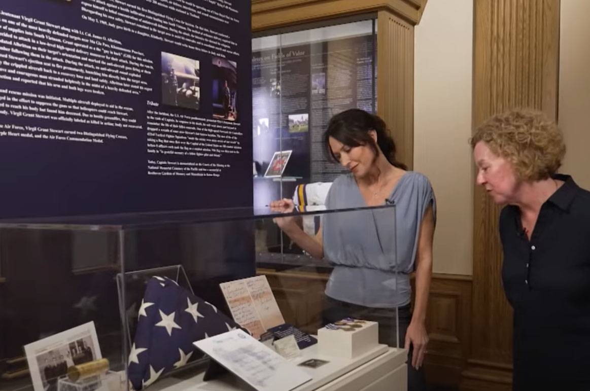 Kim Carroll, right, looks at an LSU Military Museum display featuring her father's story.