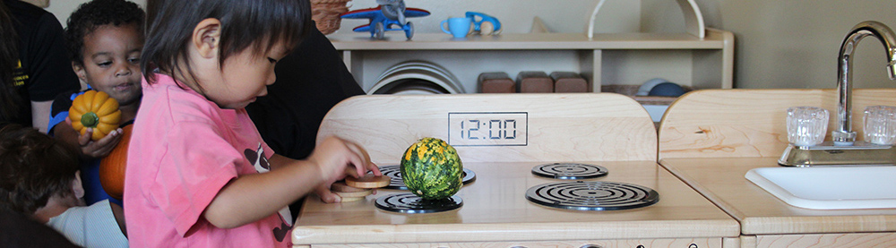 child playing with kitchen set