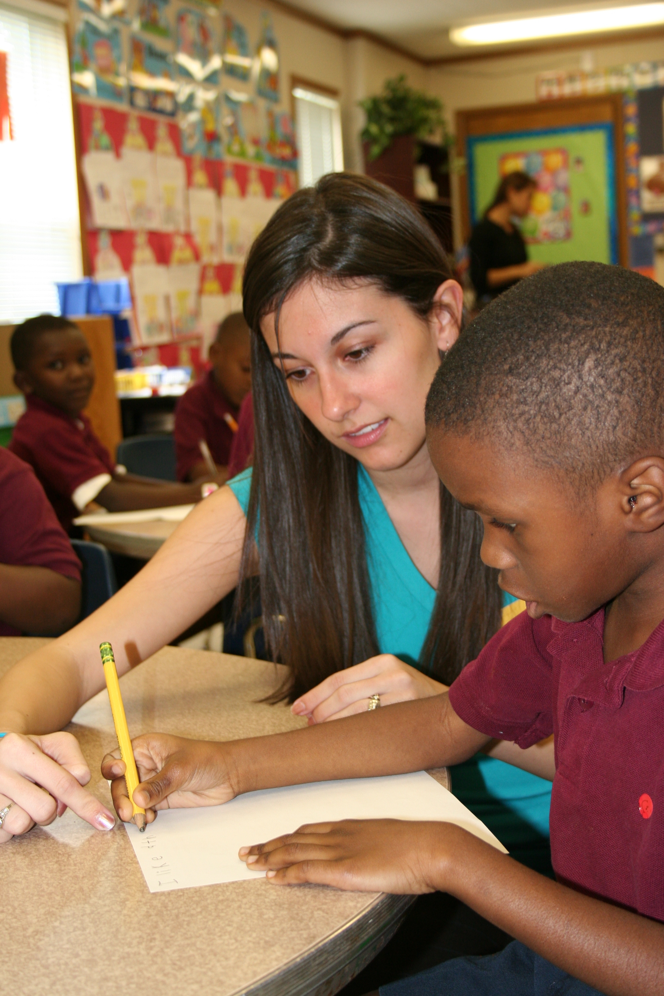 student helping young child