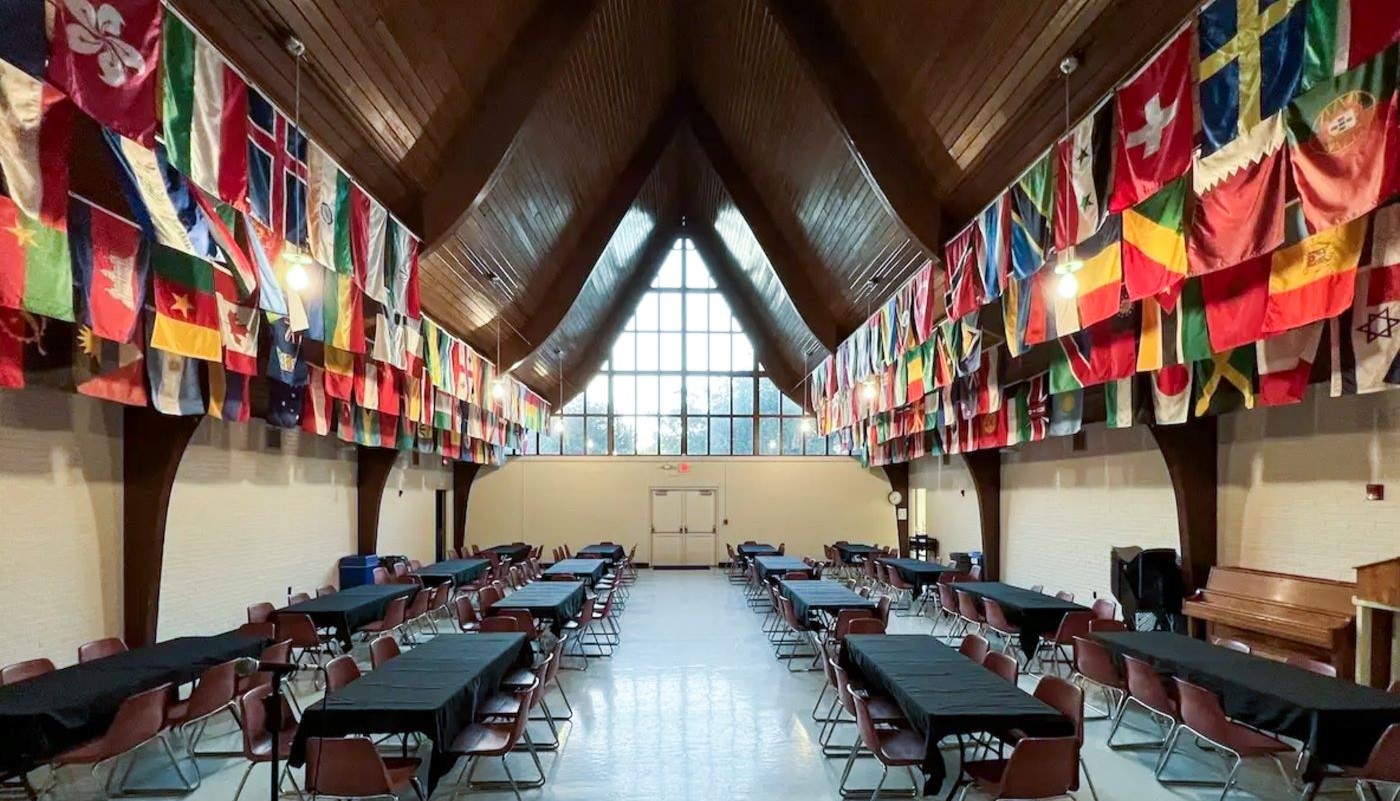 event room with many national flags hanging from ceiling