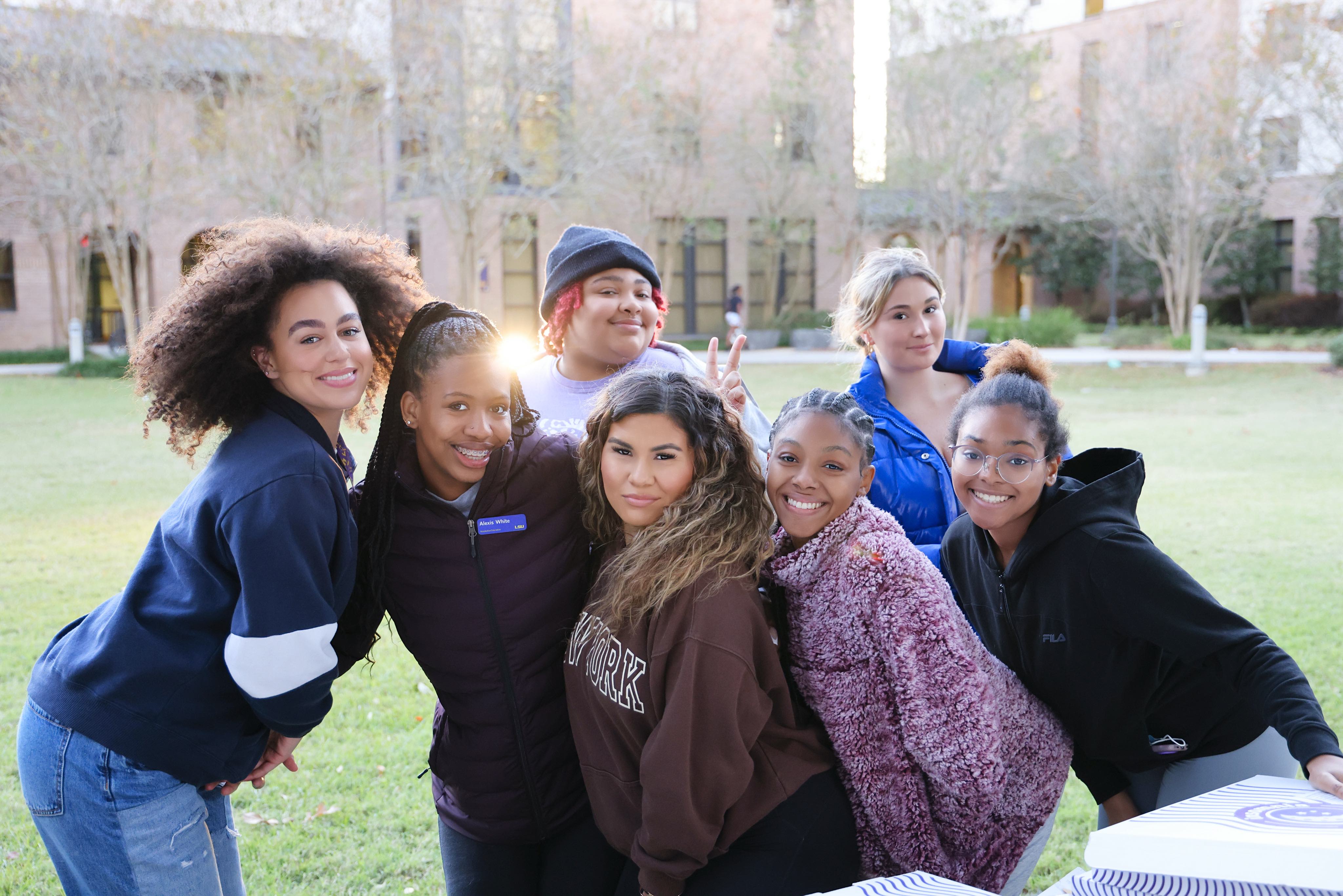 Students posing for a photo outside of West Hall