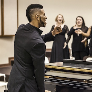 Student teaching a choir class. 