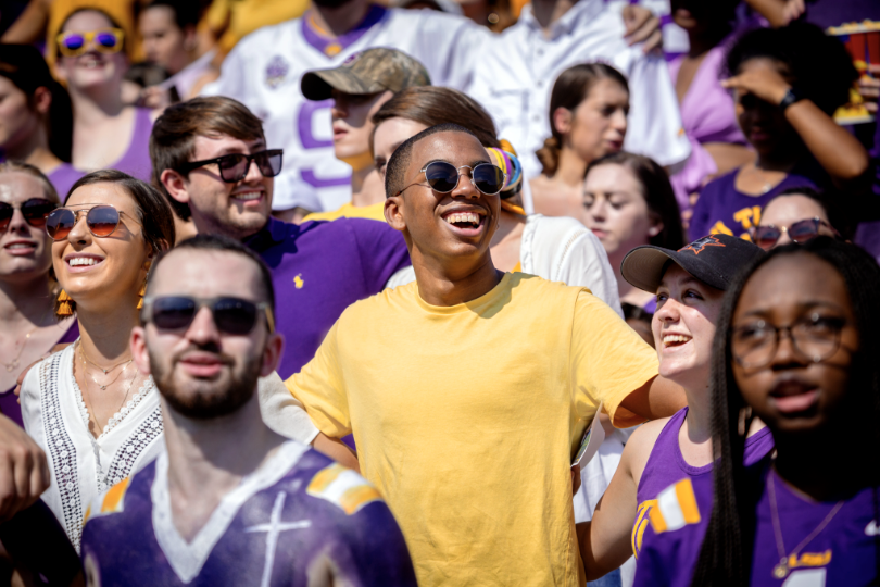 student singing alma mater in tiger stadium